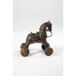 Temple toy. India, 19th century. Saddled and bridled horse on wheels. Bronze. 14.5 x 9 x12.5 cm.