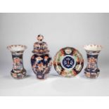 Convolute four parts Imari porcelain. Japan, 19th century. Consisting of a plate, a liddedvase and