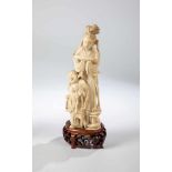 Guanyin. China, Qing Dynasty, 19th century. Guanyin with boy. Ivory carved, on woodenbase. 23.5 cm