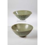 Two celadon bowls. China, probably Ming Dynasty 16th century. Wall with relief lotus leafdecoration,