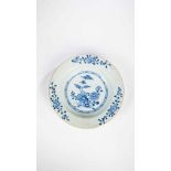 Plate. China, probably 19th century. Under glaze blue floral decor. D .: 22.7 cm. Tracesof age and