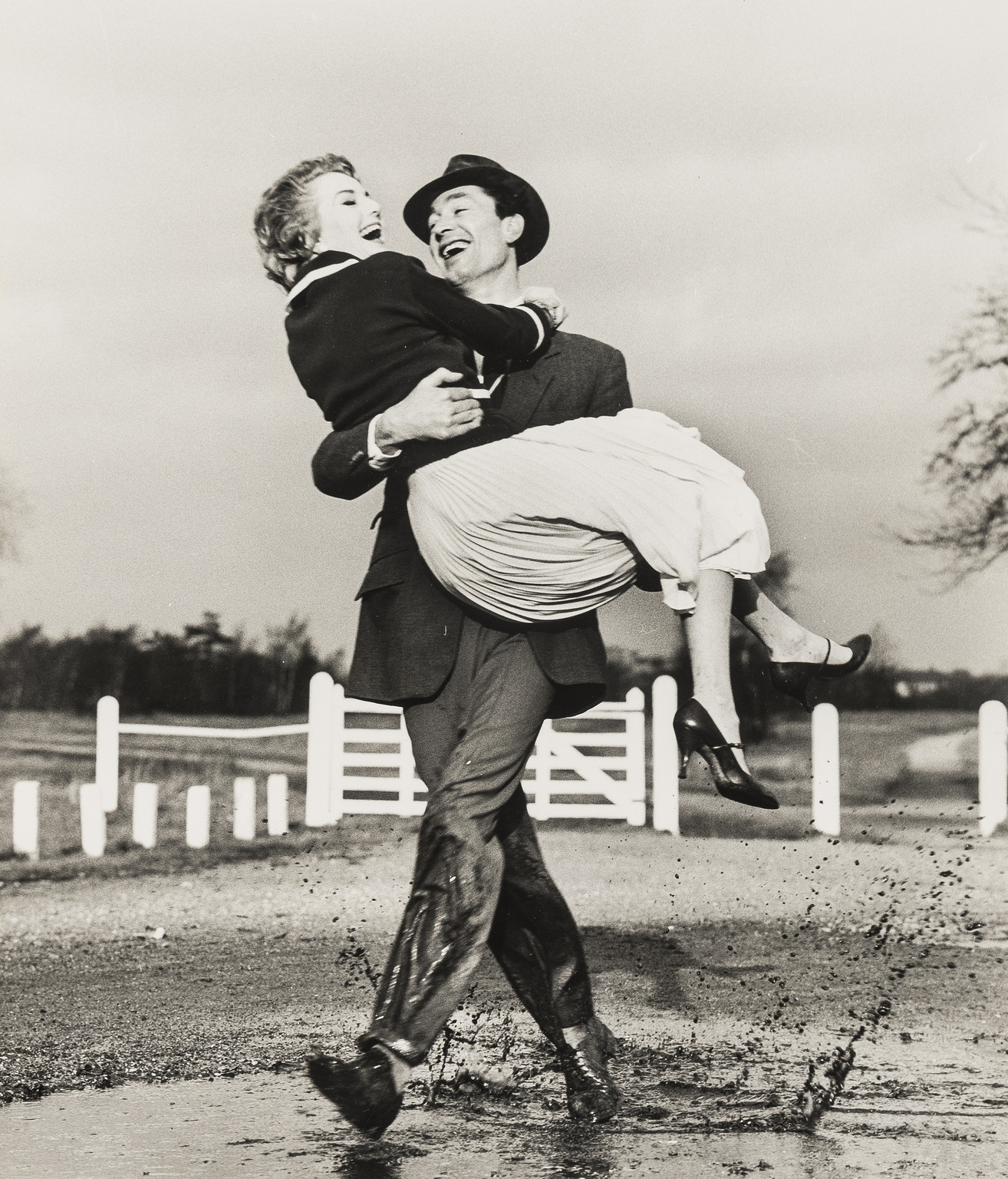 NO RESERVE Norman Parkinson (1913-1990) Woman at Window Looking at Man; Carrying Across Puddle - Image 2 of 3