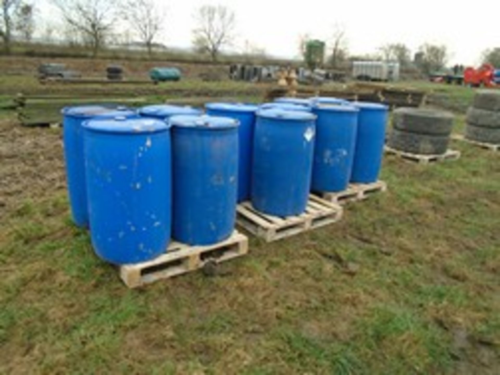 11 blue plastic barrels