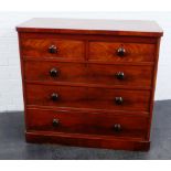 Victorian mahogany chest, the rectangular top over two short and three long drawers with bun handles