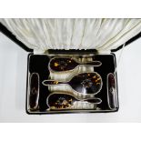 George V silver and tortoiseshell backed dressing table brush set comprising hand mirror, two hair
