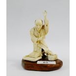 Early 20th century ivory Okimono of a kneeling man and his cat playing with a mouse, signed to base,