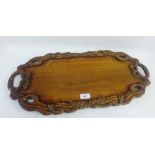 Carved Indian tray with snake carved rim and twin handles, 65cm long
