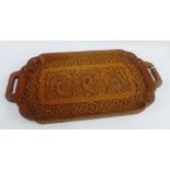 Indian carved hardwood tray with peacocks and flowerhead pattern and twin handles, 58cm long