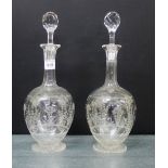Pair of etched glass globe and shaft decanters, complete with stoppers, on circular star cut