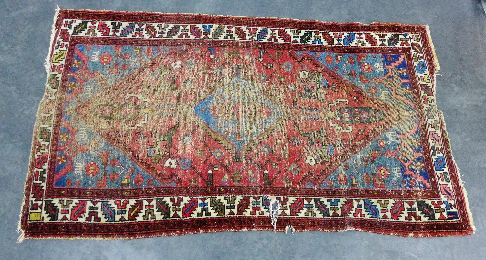 Eastern rug with worn red field, 190 x 107cm