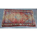 Eastern rug with worn red field, 190 x 107cm