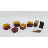 Group of late 19th century Mauchline 'Tartan Ware' to include four napkin rings, round box, needle