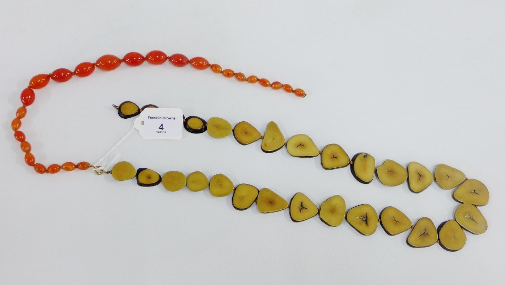 Polished palm nut necklace together with a strand of amber coloured glass beads (2)