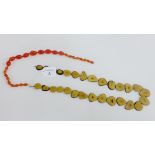Polished palm nut necklace together with a strand of amber coloured glass beads (2)