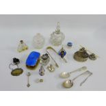 A mixed lot to include silver collared scent bottles, Sheffield silver knife rests, enamel backed