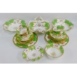 Coalport porcelain teaset comprising five cups, six saucers, six side plates, two cake plates, sugar