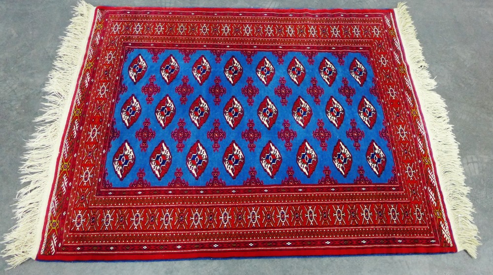 Modern Bokhara rug, the red ground with three rows of eight guls, with a red field, 200 x 140cm