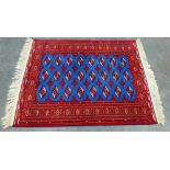 Modern Bokhara rug, the red ground with three rows of eight guls, with a red field, 200 x 140cm