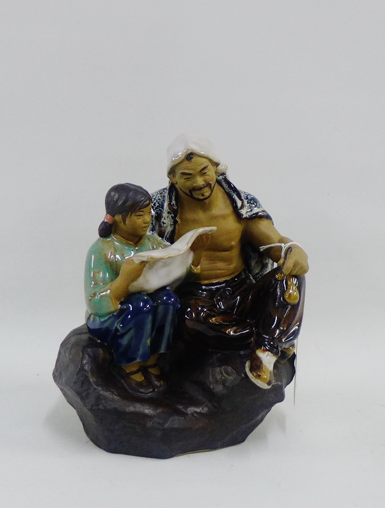 Chinese Shiwan glazed figure group of a father and daughter, 18cm high