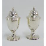 A pair of George V silver pepper pots, Chester 1911, 9cm high (2)