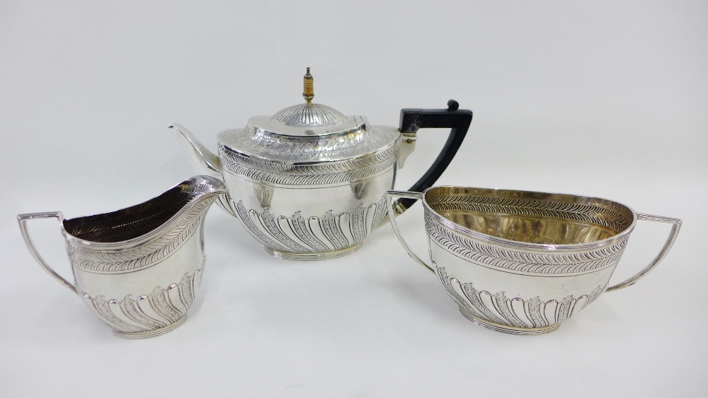 Victorian silver teaset by Edward Hutton, London 1886, comprising teapot, cream jug and twin handled