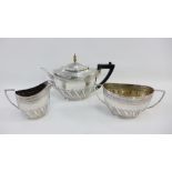 Victorian silver teaset by Edward Hutton, London 1886, comprising teapot, cream jug and twin handled