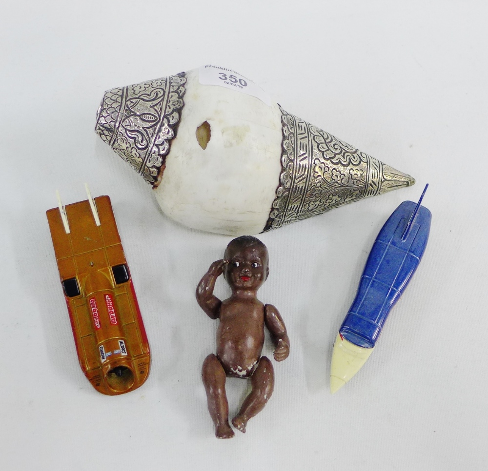 Mixed lot to include a bisque baby and two die cast cars and a white metal mounted shell, (4)