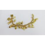 9 carat gold charm bracelet, hung with a quantity of 9 carat gold charms