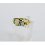 Late Victorian 18 carat gold opal and diamond dress ring, with three oval cabouchon opals and six