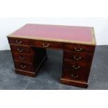 Mahogany desk with the rectangular top with red leather insert above a central frieze drawer flanked