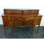 19th century mahogany serpentine sideboard with tambour sliding doors above a central frieze drawer,