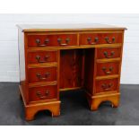 Yewwood kneehole desk, the rectangular top above two frieze drawers flanked by three small