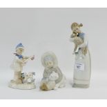 Two Lladro figures to include a 'Child with Polar Bear' and a 'Girl with Lamb' and a similar