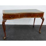 Mahogany serpentine desk / writing table with leather skivver over three small frieze drawers,