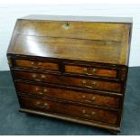 19th century oak bureau, the fall front opening to reveal a fitted interior above two short and