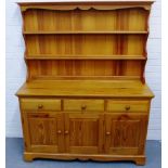 Ercol pine kitchen dresser, with shelved back over three short drawers and three cupboard doors, 168
