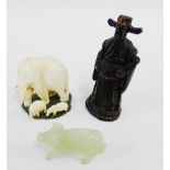 A mixed lot to include a carved wooden figure, a jadeite pig and an early 20th century carved