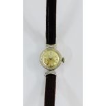 Lady's vintage Movado wristwatch in a white metal case, stamped indistinctly, with diamonds to the