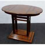 Art Deco walnut and coromandel table, the oval top on a rectangular base 78 x 94cm