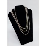 Three silver necklaces together with a pair of white metal rope twist drop earrings (4)