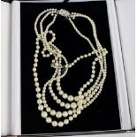 Triple strand of faux pearls and a single strand (2)