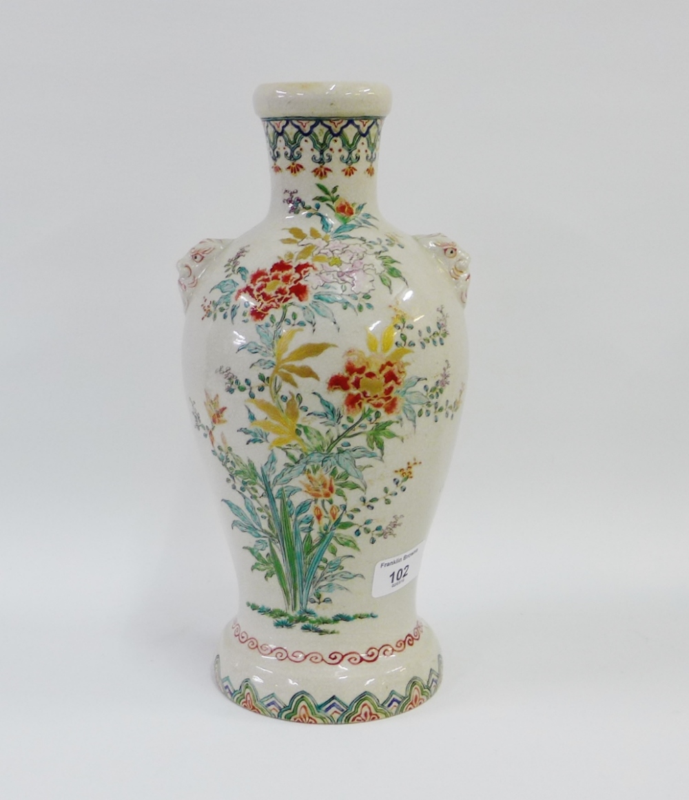 Japanese earthenware vase, the shoulders with mask heads and painted with flowers and foliage,