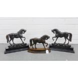 Group of three iron horse door stops, (3)