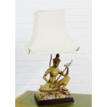 Thai gilt metal figural table lamp and shade, height excluding fitting, 47cm