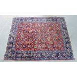 Eastern rug, the red field with allover foliate pattern within blue border