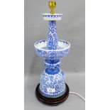 Chinese style blue and white ceramic table lamp base on a turned wooden stand