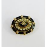19th century yellow metal and black enamel mourning brooch set with seed pearls and star motif to