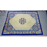 Chinese wool rug, the ivory field with a central stylised medallion within blue border, 280 x 360cm