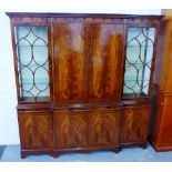 Mahogany breakfront bookcase cabinet, the stepped cornice top over two central panelled doors and