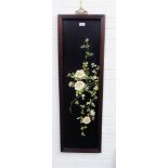 Ebonised wall plaque with rose and leaf pattern in relief, 108 x 34cm